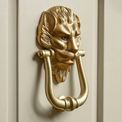 Lion door knocker on beige door