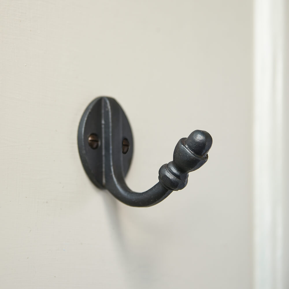 Black single hook with acorn shaped finial