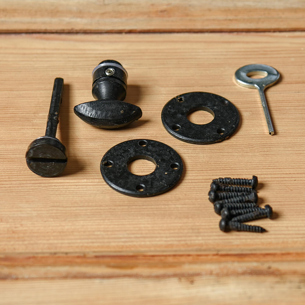 All parts supplied Black thumbturn for a bathroom door on a pine door