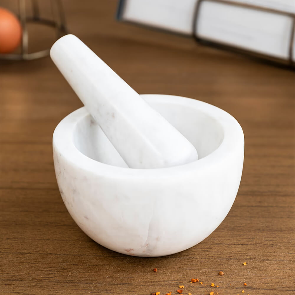 White marble pestle and mortar on worktop