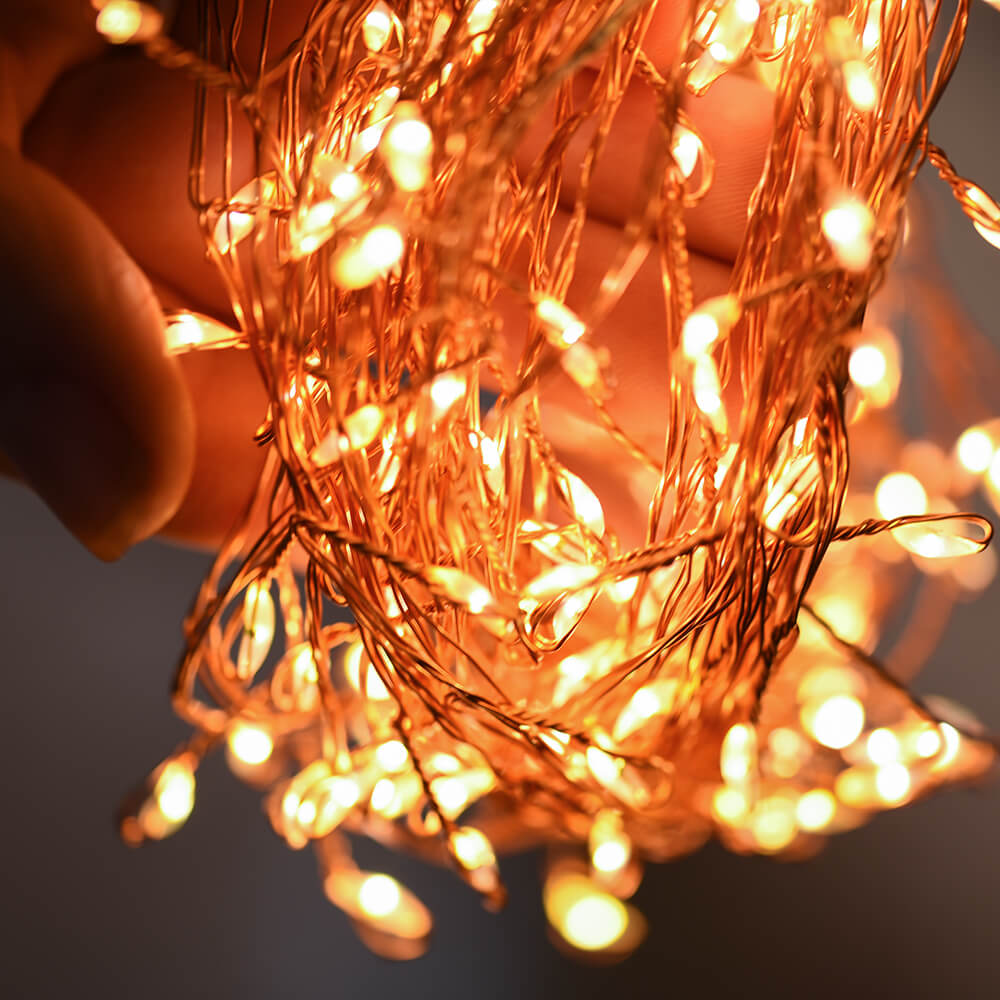 Roll of lit Copper wire led lights being held in hands