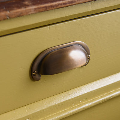 Curved drawer pull on yellow drawer