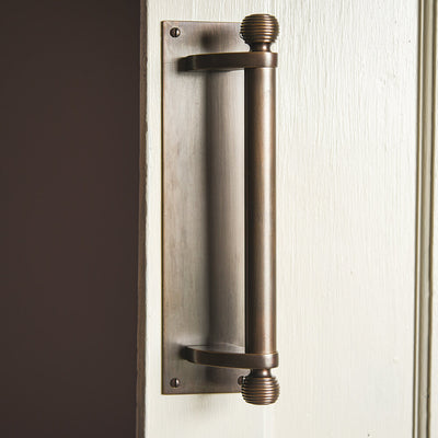 Large door pull handle with beehive finials top and bottom