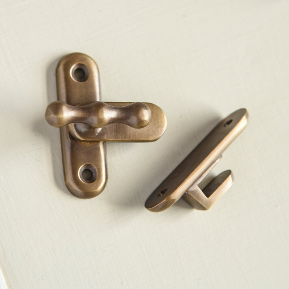 Two parts of a cabinet latch