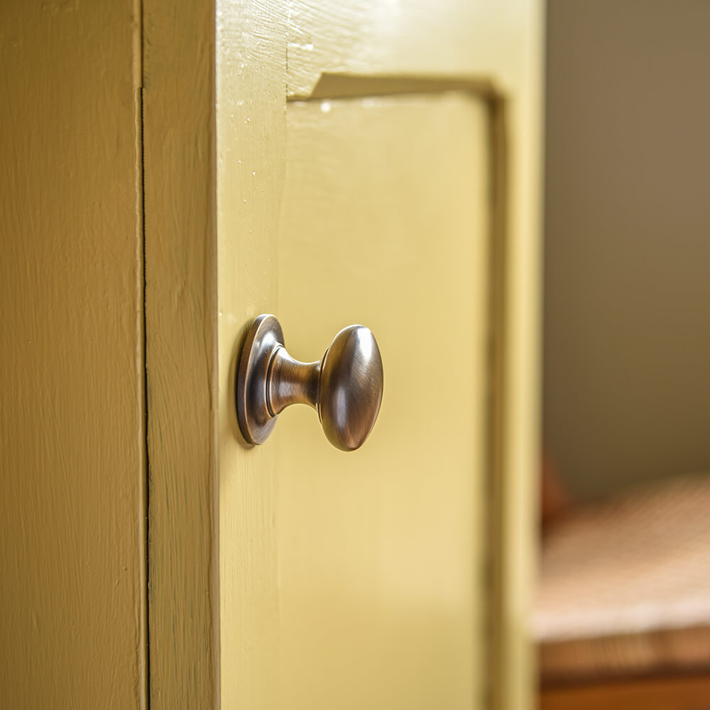 Light-Antique-Brass-Cabinet-Knob-on-Yellow-Kitchen