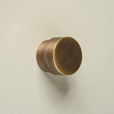 Circular cabinet knob  with a Brush brass finish