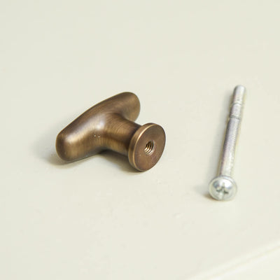 Light Antique Brass Elegance Cabinet Knob from the rear showing screw and screw hole