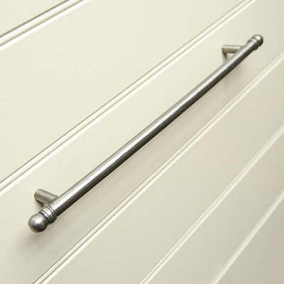 Large sized iron pull handle on a kitchen cabinet