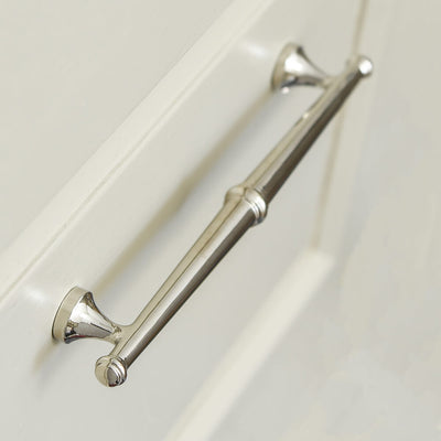 Elongated nickel plated drawr pull in a decorative Regency style