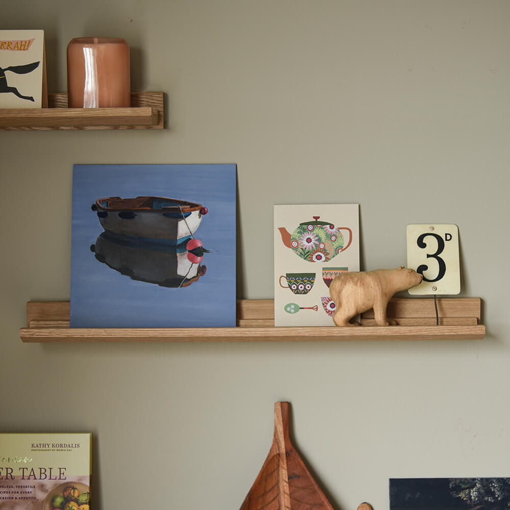 Picture ledges - medium - featuring a blue painting of a boat and collected objects