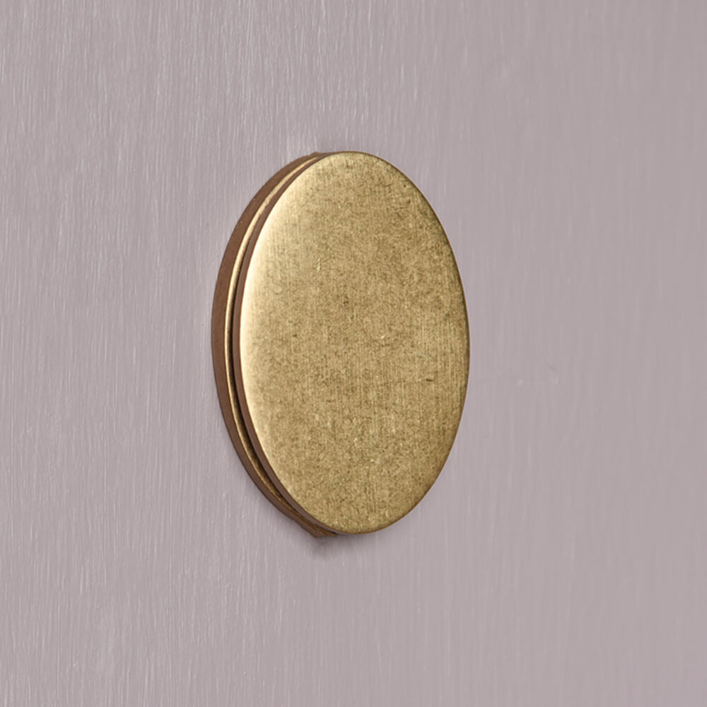 Ageed Brass oval keyhole cover on a lilac door