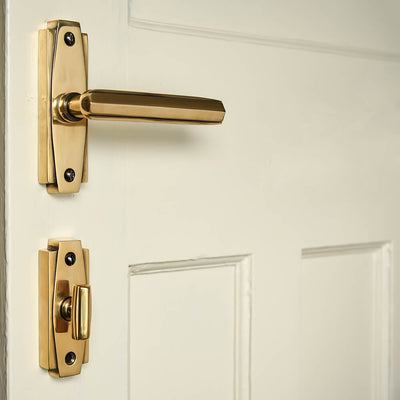 Art deco styled brass levr handles and thumbturn on cream door