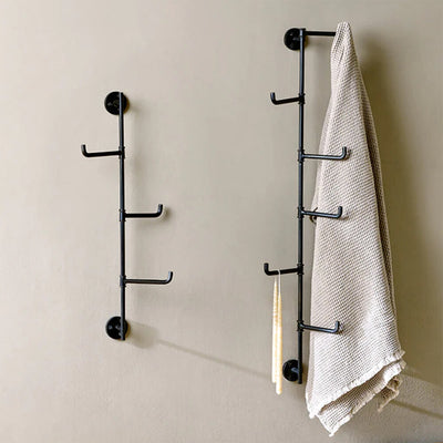 Vertical Hook rails on wall in two sizes with a tea towel hung from one