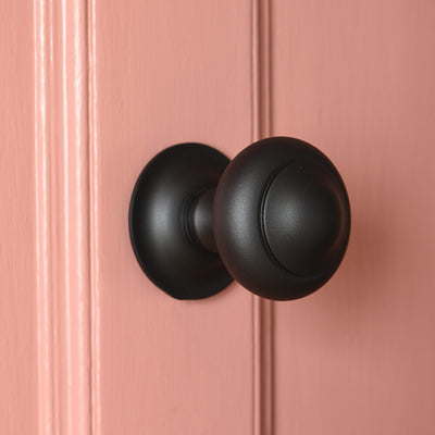 Round matt black 3 inch center door pull on salmon pink door