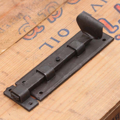 A forged black beeswax door bolt showing the beeswax finish